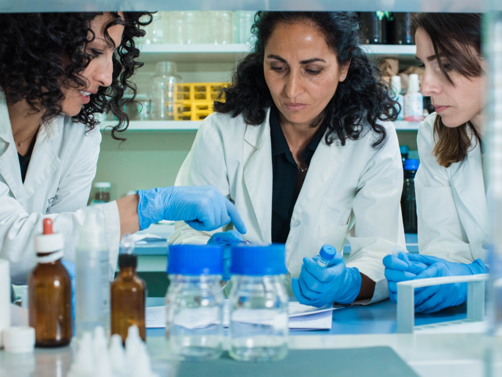 A group of female scientists, working at a fem-tech startup, doing lap work.